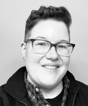 A smiling person with glasses 